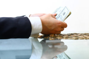 hands counting dollar money on white background